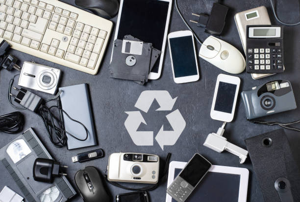 Old electronic devices on a dark background. The concept of recycling and disposal of electronic waste